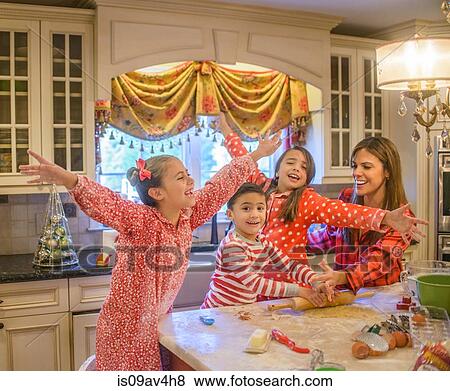 Mother and children fooling around in kitchen View Large Photo Image Stock Photo - Mother and children fooling around in kitchen. Fotosearch