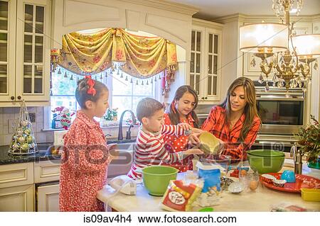 Mother and children in kitchen, baking View Large Photo Image Picture - Mother and children in kitchen, baking. Fotosearch