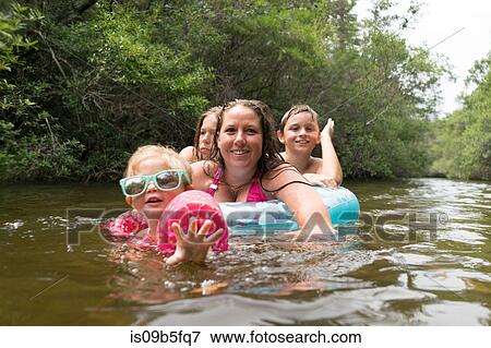 Mother and children with inflatable ring in lake, Niceville, Florida, USA View Large Photo Image Stock Photo - Mother and children with inflatable ring in lake, Niceville, Florida, USA. Fotosearch