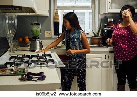 Mother and daughter in kitchen preparing smoothies View Large Photo Image Stock Image - Mother and daughter in kitchen preparing smoothies. Fotosearch
