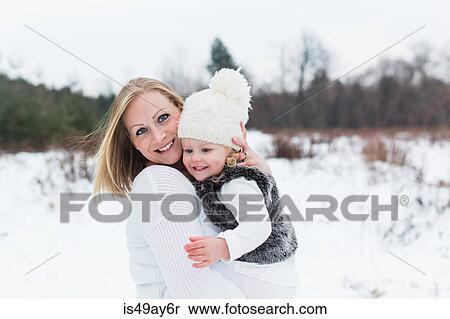 Stock Photography - Mother and daughter in snow-covered park, Oshawa, Canada. Fotosearch