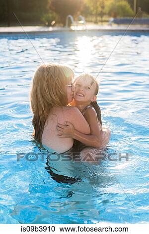 Mother and daughter in swimming pool, hugging View Large Photo Image Stock Image - Mother and daughter in swimming pool, hugging. Fotosearch