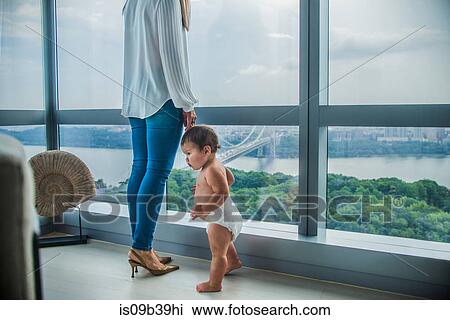 Mother and son at window overlooking bay View Large Photo Image Stock Image - Mother and son at window overlooking bay. Fotosearch