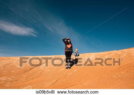 Stock Image - Mother and son exploring in desert, Moab, Utah, USA. Fotosearch