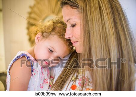 Mother comforting daughter in arms View Large Photo Image Stock Photo - Mother comforting daughter in arms. Fotosearch