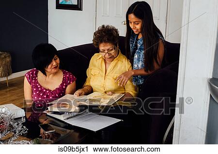Mother, grandmother and girl looking at photo album View Large Photo Image Stock Image - Mother, grandmother and girl looking at photo album. Fotosearch