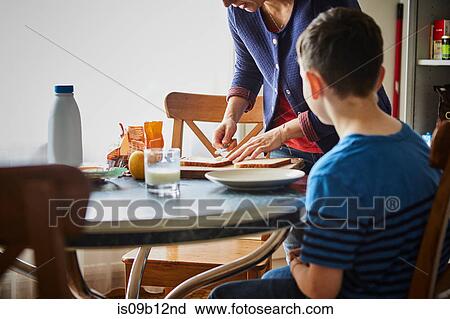 Mother making son sandwich View Large Photo Image Stock Image - Mother making son sandwich. Fotosearch