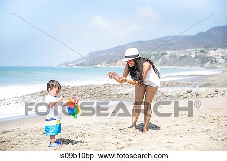 Mother photographing baby son on beach, Malibu, California, USA View Large Photo Image Stock Photography - Mother photographing baby son on beach, Malibu, California, USA. Fotosearch