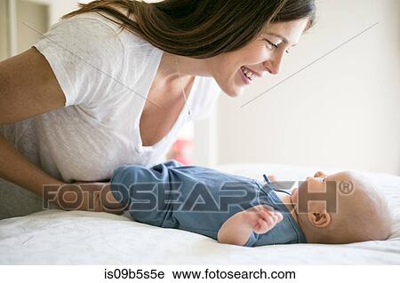 Mother playing with baby boy, face to face, smiling View Large Photo Image Stock Image - Mother playing with baby boy, face to face, smiling. Fotosearch