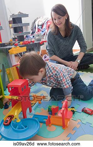Stock Image - Mother playing with son at home. Fotosearch