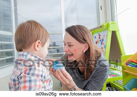 Mother playing with son at home View Large Photo Image Stock Image - Mother playing with son at home. Fotosearch