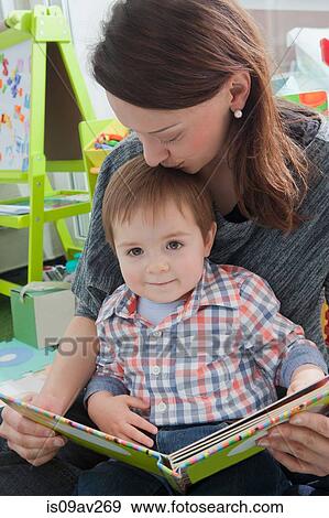 Mother reading to son at home View Large Photo Image Stock Photo - Mother reading to son at home. Fotosearch