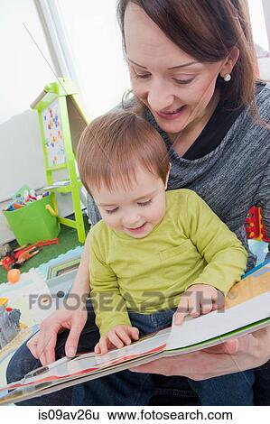Mother reading to son at home View Large Photo Image Stock Photograph - Mother reading to son at home. Fotosearch