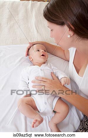 Stock Photograph - Mother soothing baby boy. Fotosearch