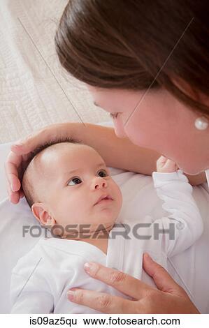 Mother soothing baby boy View Large Photo Image Stock Photograph - Mother soothing baby boy. Fotosearch