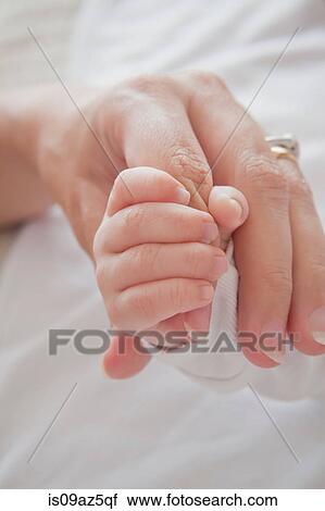 Mothers hand holding baby boys hand View Large Photo Image Stock Image - Mothers hand holding baby boys hand. Fotosearch