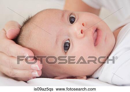 Mothers hand soothing baby boy View Large Photo Image Stock Photograph - Mothers hand soothing baby boy. Fotosearch