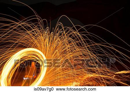 One person creating yellow circular light trails and sparks at night View Large Photo Image Stock Image - One person creating yellow circular light trails and sparks at night. Fotosearch