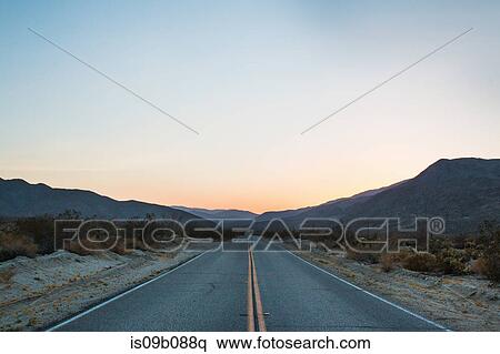 Open road to mountains at sunset, Anza Borrego, California, USA View Large Photo Image Stock Photography - Open road to mountains at sunset, Anza Borrego, California, USA. Fotosearch