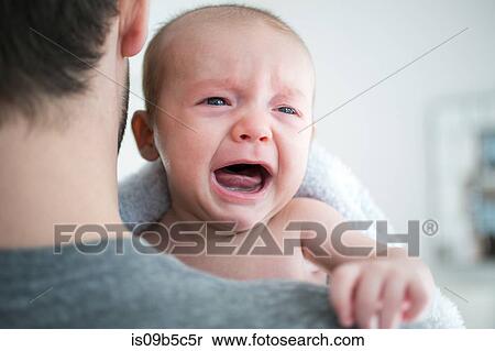 Over shoulder view of man carrying crying baby son View Large Photo Image Stock Photography - Over shoulder view of man carrying crying baby son. Fotosearch