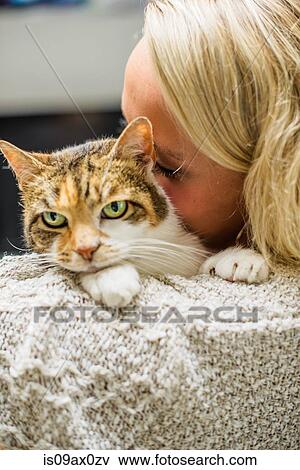 Over the shoulder of woman nuzzling cat View Large Photo Image Stock Photo - Over the shoulder of woman nuzzling cat. Fotosearch