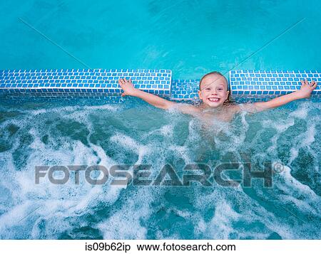 Overhead portrait of cute boy splashing in outdoor swimming pool View Large Photo Image Stock Photography - Overhead portrait of cute boy splashing in outdoor swimming pool. Fotosearch