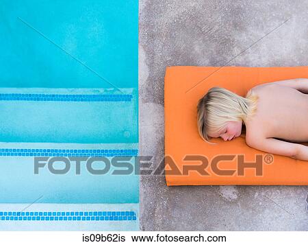 Overhead view of boy lying on poolside View Large Photo Image Stock Photograph - Overhead view of boy lying on poolside. Fotosearch