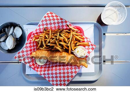 Overhead view of fish and chips on tray with bowl of scallops, Lunenburg, Nova Scotia, Canada View Large Photo Image Stock Image - Overhead view of fish and chips on tray with bowl of scallops, Lunenburg, Nova Scotia, Canada. Fotosearch