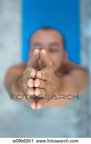 Overhead view of man practicing yoga, standing on yoga mat with hands together View Large Photo Image Stock Image - Overhead view of man practicing yoga, standing on yoga mat with hands together. Fotosearch