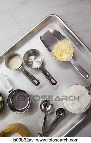 Overhead view of raw pastry baking ingredients with scoop and measuring spoons View Large Photo Image Stock Photo - Overhead view of raw pastry baking ingredients with scoop and measuring spoons. Fotosearch