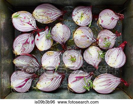 Overhead view of red onion halves with rosemary and olive oil in roasting tin View Large Photo Image Stock Photograph - Overhead view of red onion halves with rosemary and olive oil in roasting tin. Fotosearch
