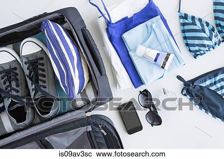 Overhead view of suitcase being packed for vacation View Large Photo Image Stock Image - Overhead view of suitcase being packed for vacation. Fotosearch