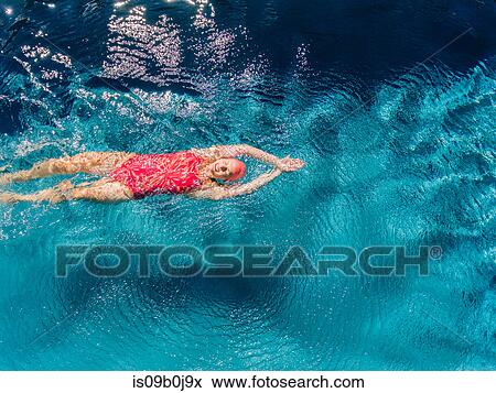 Overhead view of woman swimming on back in swimming pool View Large Photo Image Stock Photo - Overhead view of woman swimming on back in swimming pool. Fotosearch
