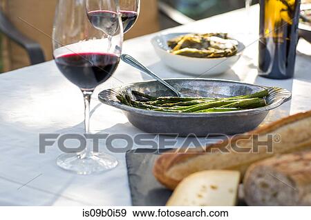 Party garden table with red wine, cheese board and green beans View Large Photo Image Stock Photo - Party garden table with red wine, cheese board and green beans. Fotosearch