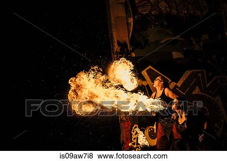 Performers fire breathing in urban area View Large Photo Image Stock Photo - Performers fire breathing in urban area. Fotosearch