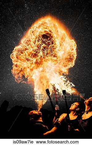Performers fire breathing, starry night sky View Large Photo Image Stock Image - Performers fire breathing, starry night sky. Fotosearch