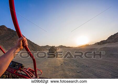 Personal perspective view of man's arm driving beach buggy in desert, Hurghada, Al Bahr al Ahmar, Egypt View Large Photo Image Stock Photograph - Personal perspective view of man's arm driving beach buggy in desert, Hurghada, Al Bahr al Ahmar, Egypt. Fotosearch