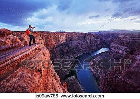 Stock Photograph - Photographer taking picture, Colorado River, Arizona. Fotosearch
