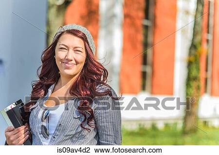 Stock Image - Portrait of adult female college student on campus. Fotosearch