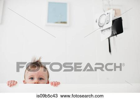 Portrait of baby boy staring from crib View Large Photo Image Stock Image - Portrait of baby boy staring from crib. Fotosearch