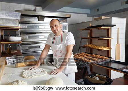 Stock Photo - Portrait of baker in bakery. Fotosearch