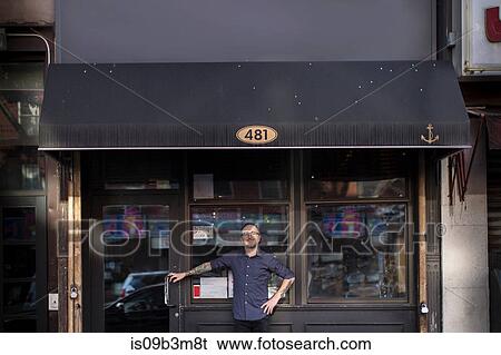 Portrait of barman outside public house window, Brooklyn, New York, USA View Large Photo Image Stock Photograph - Portrait of barman outside public house window, Brooklyn, New York, USA. Fotosearch