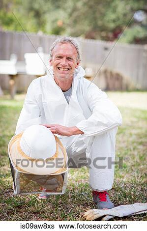 Stock Photograph - Portrait of beekeeper, smiling. Fotosearch