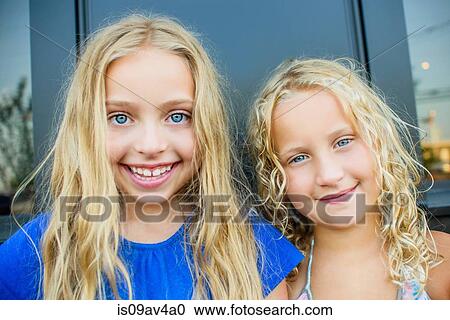 Portrait of blond haired and blue eyed sisters at sidewalk cafe View Large Photo Image Stock Image - Portrait of blond haired and blue eyed sisters at sidewalk cafe. Fotosearch