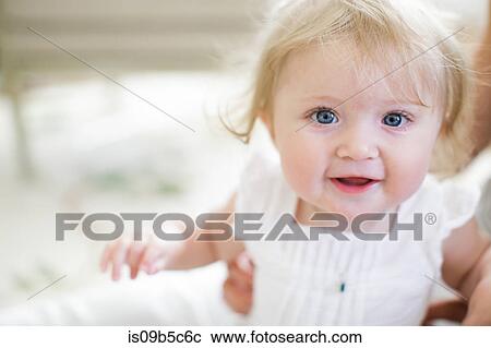 Stock Image - Portrait of blue eyed baby girl. Fotosearch