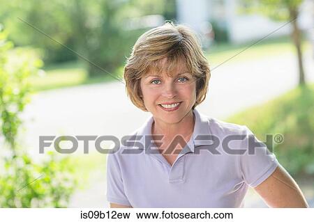 Portrait of blue eyed mature woman in garden View Large Photo Image Stock Photo - Portrait of blue eyed mature woman in garden. Fotosearch
