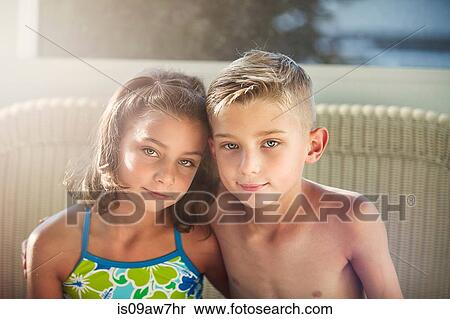 Portrait of boy and girl arms around each other looking at camera smiling View Large Photo Image Stock Photography - Portrait of boy and girl arms around each other looking at camera smiling. Fotosearch