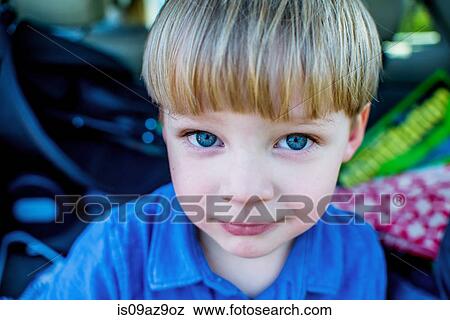 Stock Photo - Portrait of boy looking at camera smiling. Fotosearch