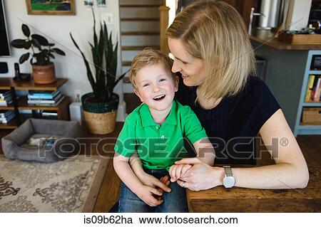 Portrait of boy sitting at table on mother's lap View Large Photo Image Stock Image - Portrait of boy sitting at table on mother's lap. Fotosearch
