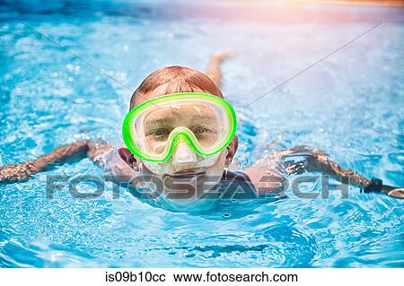 Portrait of boy wearing green scuba mask swimming in sunlit swimming pool View Large Photo Image Stock Image - Portrait of boy wearing green scuba mask swimming in sunlit swimming pool. Fotosearch